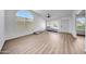 Bright living room with large arched window and modern wood-look flooring at 23638 N 41St Ave, Glendale, AZ 85310