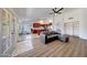 Spacious open-concept living room features wood-look flooring, and a view to the kitchen with a bar seating area at 23638 N 41St Ave, Glendale, AZ 85310