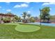 Lush backyard with putting green, sport court, pool with water feature and outdoor bar at 2371 E Sanoque Ct, Gilbert, AZ 85298