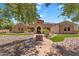 Stunning stone home featuring a well-manicured front yard and desert landscaping at 2371 E Sanoque Ct, Gilbert, AZ 85298