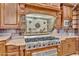 Chef's kitchen featuring a stainless steel range, custom hood, and granite countertops at 2371 E Sanoque Ct, Gilbert, AZ 85298