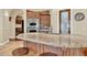 Kitchen island featuring barstool seating, granite countertops, and custom cabinetry at 2371 E Sanoque Ct, Gilbert, AZ 85298