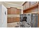Laundry room boasting ample cabinetry for storage, complemented by modern washer and dryer units at 2371 E Sanoque Ct, Gilbert, AZ 85298