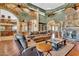 Spacious living room with high ceilings, stone accent wall, and beautiful hardwood floors at 2371 E Sanoque Ct, Gilbert, AZ 85298