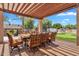 Spacious outdoor dining area with an expansive pergola and outdoor kitchen nearby at 2371 E Sanoque Ct, Gilbert, AZ 85298