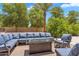 Gather around the modern firepit in this backyard seating area with plush blue cushions at 2371 E Sanoque Ct, Gilbert, AZ 85298