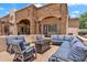 Relax outdoors in a comfortable seating area with a fire pit and views of the backyard at 2371 E Sanoque Ct, Gilbert, AZ 85298