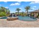 Resort-style pool with a rock waterfall feature, slide, and swim-up bar under a cabana at 2371 E Sanoque Ct, Gilbert, AZ 85298