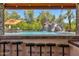 Unique view of the outdoor bar, custom pool with waterfall and slide from the outdoor bar at 2371 E Sanoque Ct, Gilbert, AZ 85298