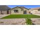 Manicured backyard featuring gravel, pavers and synthetic grass at 24035 W La Salle St, Buckeye, AZ 85326