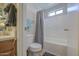 Bright bathroom with a toilet and bathtub, featuring a shower curtain and window at 24035 W La Salle St, Buckeye, AZ 85326