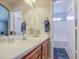 Bright bathroom with a sink, vanity, and bathtub, featuring a gray shower curtain at 24035 W La Salle St, Buckeye, AZ 85326
