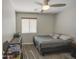 Bedroom featuring a ceiling fan, window with blinds, bed, and dresser at 24035 W La Salle St, Buckeye, AZ 85326