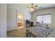 Cozy bedroom with en-suite bathroom, study area, and carpeted floors at 24035 W La Salle St, Buckeye, AZ 85326