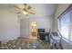 Bedroom featuring en-suite bathroom, natural light, carpet, and ceiling fan at 24035 W La Salle St, Buckeye, AZ 85326