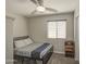 Cozy bedroom with ceiling fan, window, and a bed with patterned bedding at 24035 W La Salle St, Buckeye, AZ 85326