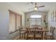 Inviting dining room with rustic wood table, modern chairs, and natural light from large window at 24035 W La Salle St, Buckeye, AZ 85326