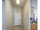 Bright entryway featuring neutral walls, ceramic tile flooring, and a traditional white front door at 24035 W La Salle St, Buckeye, AZ 85326
