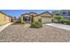 Single-Gathering home with desert landscaping, well-maintained bushes, and a spacious two-car garage at 24035 W La Salle St, Buckeye, AZ 85326