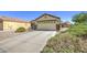 Single-Gathering home with desert landscaping, well-maintained bushes, and a spacious two-car garage at 24035 W La Salle St, Buckeye, AZ 85326