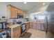 Well-maintained kitchen with wooden cabinetry, modern appliances, and tile flooring at 24035 W La Salle St, Buckeye, AZ 85326