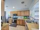 Bright kitchen featuring wood cabinets, countertops, stainless appliances, and tile flooring at 24035 W La Salle St, Buckeye, AZ 85326