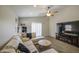 Inviting living room with large television, comfortable sectional sofa, and natural light at 24035 W La Salle St, Buckeye, AZ 85326