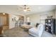 Cozy living room featuring an open floor plan, ceiling fan, and breakfast bar seating at 24035 W La Salle St, Buckeye, AZ 85326