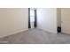 Clean bedroom with neutral carpet and a window providing natural light at 2430 E Alonso Dr, Casa Grande, AZ 85194