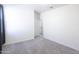 Spacious bedroom with neutral carpet and a door leading to another room at 2430 E Alonso Dr, Casa Grande, AZ 85194