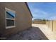 Exterior shot of the side of the home, emphasizing privacy and simplicity at 2430 E Alonso Dr, Casa Grande, AZ 85194