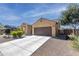 Single-story home with a two car garage, a private drive, and desert landscaping at 2430 E Alonso Dr, Casa Grande, AZ 85194