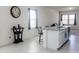 Bright, neutral kitchen with a granite island and bar stool seating at 2430 E Alonso Dr, Casa Grande, AZ 85194