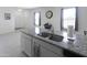 Close-up on a kitchen island with a stainless steel sink and granite countertop at 2430 E Alonso Dr, Casa Grande, AZ 85194