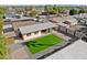 Birds-eye view of a backyard oasis with artificial turf, brick patio, covered patio and desert landscaping at 2525 E Nisbet Rd, Phoenix, AZ 85032