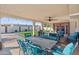 Inviting covered patio features a built-in grill, ceiling fan, comfortable seating, and stylish outdoor dining set at 2525 E Nisbet Rd, Phoenix, AZ 85032