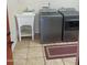 Bright laundry area with modern washer and dryer, utility sink, and tile flooring at 2525 E Nisbet Rd, Phoenix, AZ 85032