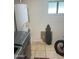 Tiled laundry room with water heater and storage at 2525 E Nisbet Rd, Phoenix, AZ 85032