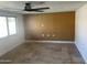 Sunlit living room featuring a gold accent wall and stone tile floors at 2525 E Nisbet Rd, Phoenix, AZ 85032