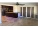 Open living area with travertine floors, ceiling fan and view of updated kitchen at 2525 E Nisbet Rd, Phoenix, AZ 85032