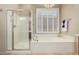 Bright bathroom features walk-in shower, soaking tub, and plantation shutters at 2554 E Honeysuckle Pl, Chandler, AZ 85286