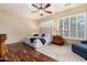 Comfortable bedroom with a large bed, two side tables, wood floors, and shuttered windows at 2554 E Honeysuckle Pl, Chandler, AZ 85286