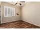 This bedroom features wood floors, plantation shutters, and a ceiling fan at 2554 E Honeysuckle Pl, Chandler, AZ 85286