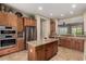 Modern kitchen features stainless steel appliances, granite countertops, and ample cabinet space at 2554 E Honeysuckle Pl, Chandler, AZ 85286