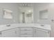 Bright bathroom featuring dual sinks, corner vanity and framed mirrors at 2650 W Union Hills Dr # 269, Phoenix, AZ 85027
