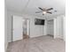 Spacious carpeted bedroom featuring ceiling fan, mounted TV and large closet at 2650 W Union Hills Dr # 269, Phoenix, AZ 85027