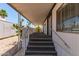 Mobile home stairway to a covered porch with white railings, desert landscaping and cacti at 2650 W Union Hills Dr # 269, Phoenix, AZ 85027