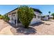 Exterior view of a single-story home with desert landscaping and a charming front porch with well-manicured lawn at 2650 W Union Hills Dr # 269, Phoenix, AZ 85027