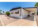 Quaint mobile home with a covered awning, a well-kept rock yard and driveway with desert landscaping at 2650 W Union Hills Dr # 269, Phoenix, AZ 85027