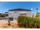Rear exterior view of a single-story home with a mature bush, and desert landscaping for low maintenance at 2650 W Union Hills Dr # 269, Phoenix, AZ 85027